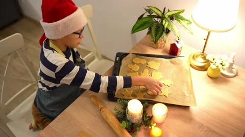 Young boys in Santa hat preparing Christmas cookies in cozy kitchen Stock Footage 297903733