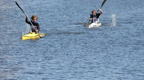 Young boys trying to win in canoe competition Stock Footage 50070051