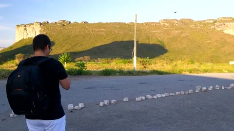 Young Brazilian man operating a drone in front of Morro do Pai Inacio. Stock Footage 154114889