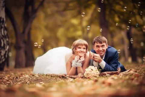 Young bride and groom on the background of autumn landscape Stock Photos