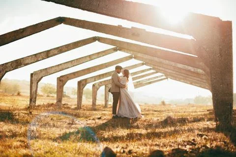 Young bride and groom couple on a field. Stock Photos