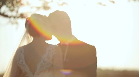 Young bride and groom at sunset hugging and kissing Video stock 57394685