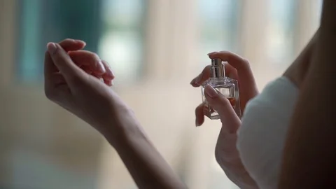 Young bride applying perfume, eau spirit fragrance. Stock Footage