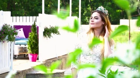 Young bride with crown walking in the park Stock Footage 77239180