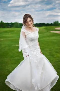 Young bride dancing on a meadow Stock Photos