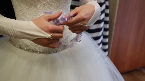 Young bride getting dressed into her wedding gown Stock Footage 52190152