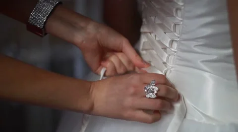 Young bride getting dressed into her wedding gown Stock Footage 52512574
