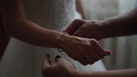 The young bride is given a gold bracelet on her arm Stock Footage 306172889