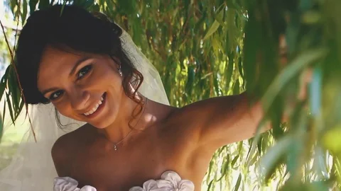 Young Bride Goes Through Tree Branches Stock Footage 75161588