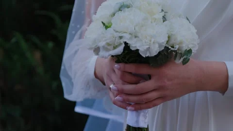 Young bride holding a beautiful wedding bouquet in her hands Stock Footage 306157301