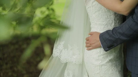 A young bride is hugging her lover. Loving couple hugging each other in a park Stock Footage 90365952