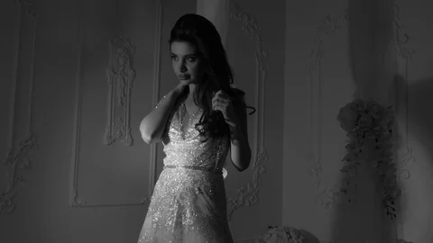 Young bride with makeup stands against white vintage wall Stock Footage 108103728