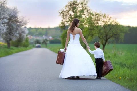 Young bride on the road with a suitcase Stock Photos