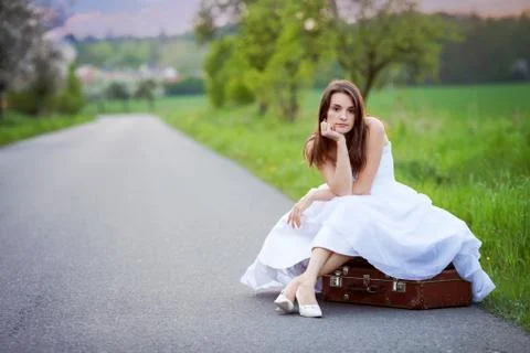Young bride on the road with a suitcase Stock Photos