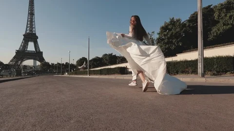 Young bride running in slow motion waving dress and long veil on background of Stock Footage 128595845