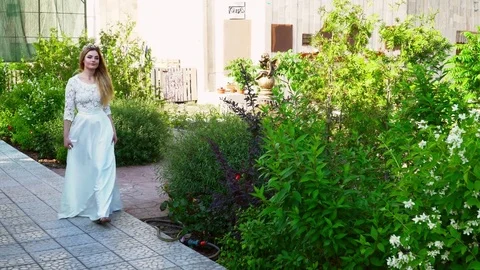 Young bride walking in the park during the summer Video stock 77239335