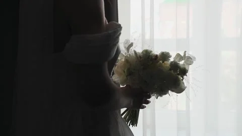A young bride with a wedding bouquet in her hands Stock Footage 327985006