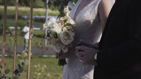 A young bride with a wedding bouquet in her hands Stockbeeldmateriaal 328048044