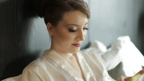 Young bride on wedding-day using mobilephone. Stock Footage 89559447