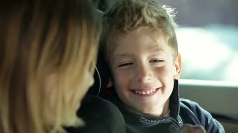 Young brother teases sister in car while family traveling Stock Footage 27846292