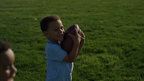 young brothers playing football together | Stock Video | Pond5