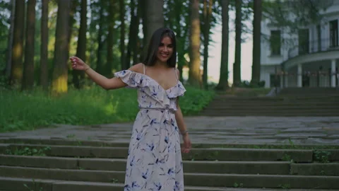 A young brunette on the background of an old manor house in a beauti Video stock 157427178