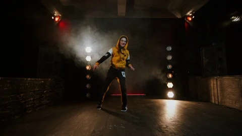 Young Brunette Dancing Break Dance In Studio. Flashing Light. Room Is Filled Vídeos de archivo 126933817