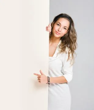 Young brunette with empty billboard. Stock Photos