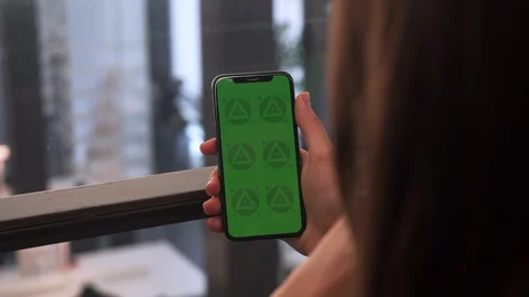 Young Brunette Female Using Mobile Phone with Green Screen Chroma Key. 4K Stock Footage 112306859