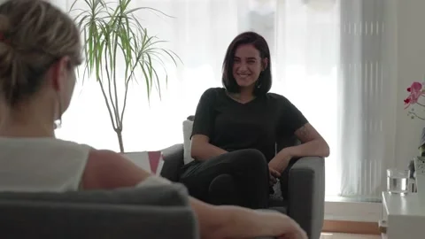 Young brunette girl laughs while talking to her psychologist Stock Footage 202102161