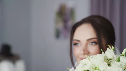 Young brunette girl looking at the camera. Luxury fashion bride in a white dress Stock Footage 243660962