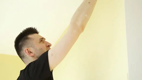 Young brunette master makes repairs in a large spacious office with panoramic Stock Footage 132792700