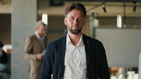 A young brunette office worker guy with stubble in a blue jacket and white shirt Stock-Footage 251115618