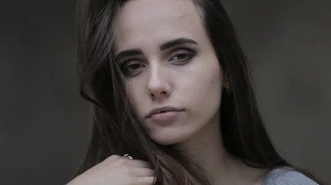 Young brunette posing in front of the camera and touching his hair Stock Footage 63911478