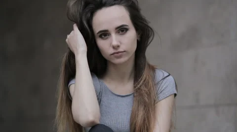 Young brunette posing in front of the camera and touching his hair Stock Footage 63911484