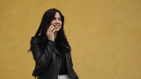 Young brunette talking to the phone Stock Footage 131982903