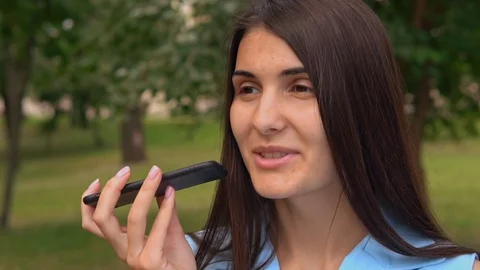 Young brunette using app voice assistant smartphone Stock Footage 129895999