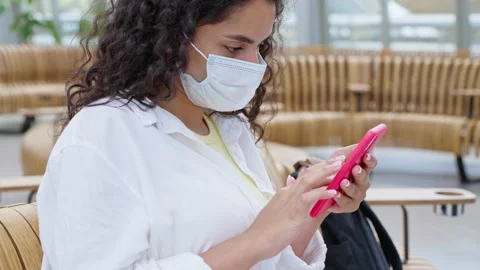 Young brunette using mobile while waiting at the station Stock Footage 232017804