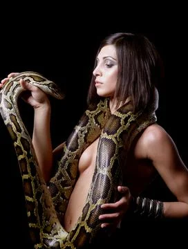 Young brunette woman holding python, big snake. Fotos de archivo