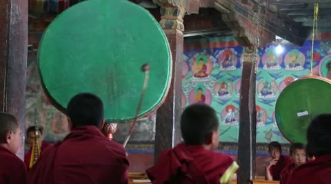 Young Buddhist Monks beating drums during morning prayers. Video stock 44181384