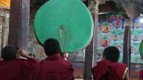 Young Buddhist Monks beating drums during morning prayers. Stock Footage 44181402
