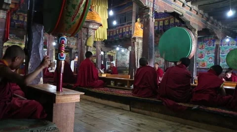 Young Buddhist Monks beating drums during morning prayers. Video stock 44181714