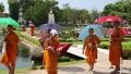 Young buddhists in yellow vestments at excursion in Mini Siam park in Pattaya HD Footage