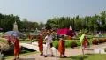 Young buddhists in yellow vestments at excursion in Mini Siam park in Pattaya HD Footage