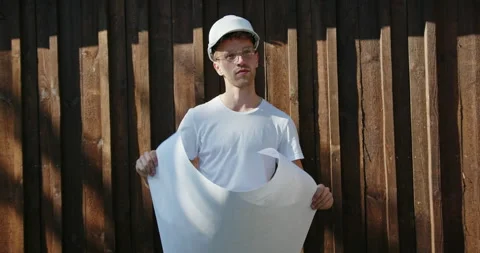 Young builder, architect or structural engineer in hardhat standing checking a Stock Footage 141535732