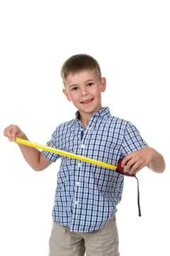 Young builder assistant in blue checkered shirt is happy to measure something Stock Photos