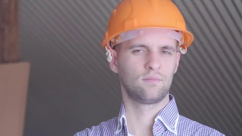 Young builder gesturing good quality at the building under construction Stock-Footage 72984782
