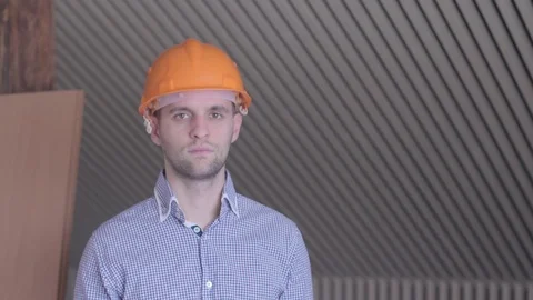 Young builder gesturing good quality at the building under construction. Close Stock Footage 72984907