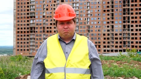 Young builder says Yes. By shaking his head. Worker says Yes, meaning YES Stock Footage 111856220