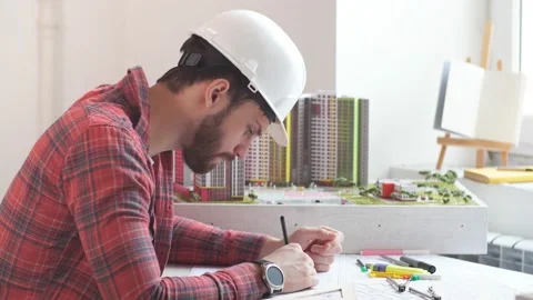 Young builder working with project in office Stock Footage 130103026